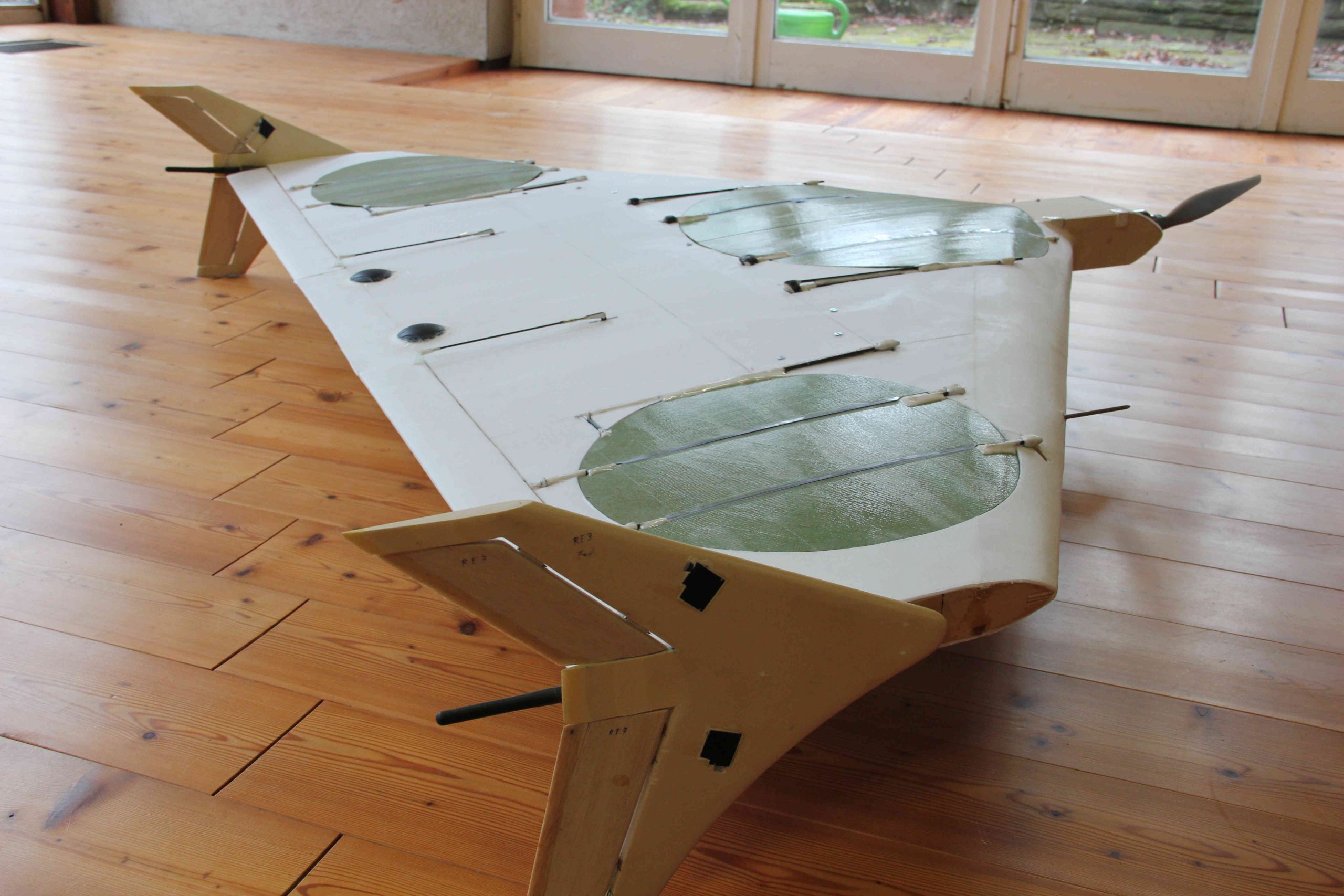 electric VTOL aircraft with wingtip fences and movable louver system, shown in airplane mode